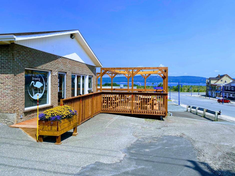 Picture of the front of Heron Bay Brewing building looking across the Restigouche River to Quebec